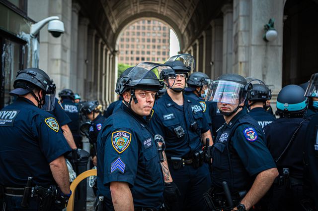 NYPD officers stand outside City Hall on July 1.